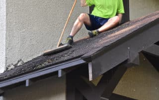 Man sits on an entryway porch of a house